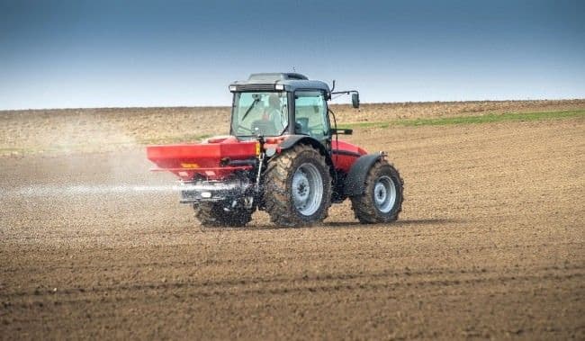 Farmer fertilizing crop