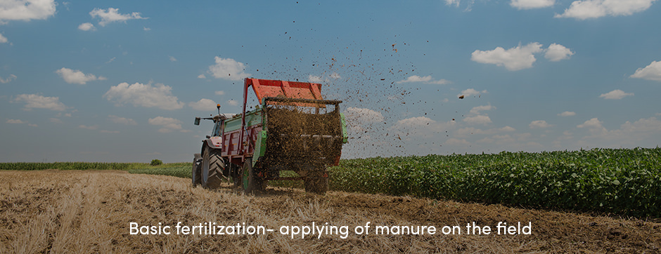Tractor fertilizing fields