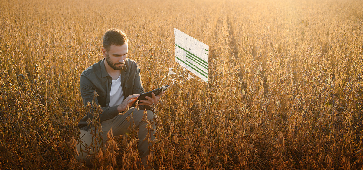 Farmer checking real-time farm operations visibility on a tablet in a field with digital cost data overlay