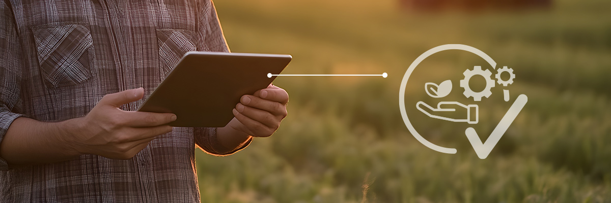 Farmer using a tablet in the field to manage farm operations visibility and connected field data
